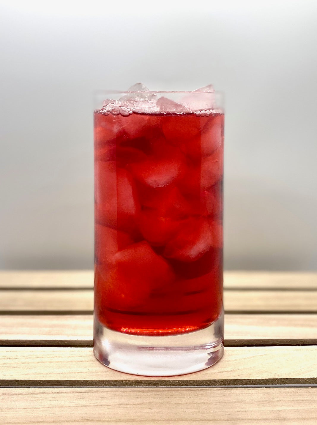Iced blood orange herbal loose leaf tea brewed to a beautiful bright pink color