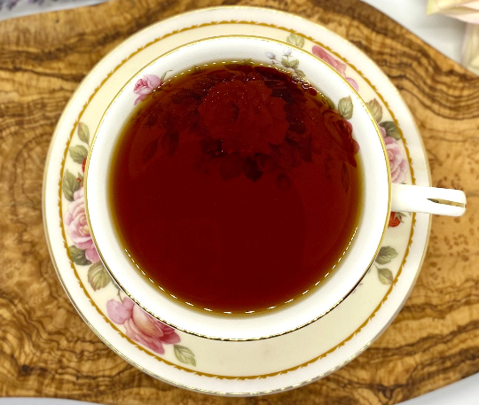 A cup of hot pumpkin spice black tea in a teacup