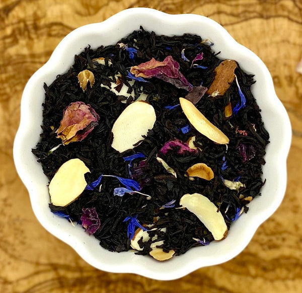 Loose leaf black tea mixed with sliced almonds, rose petals and blue flower petals
